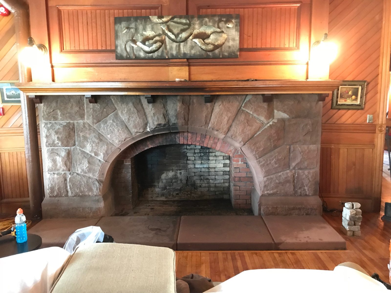 Historic masonry fireplace cleaning test showing a visible contrast between cleaned and uncleaned areas