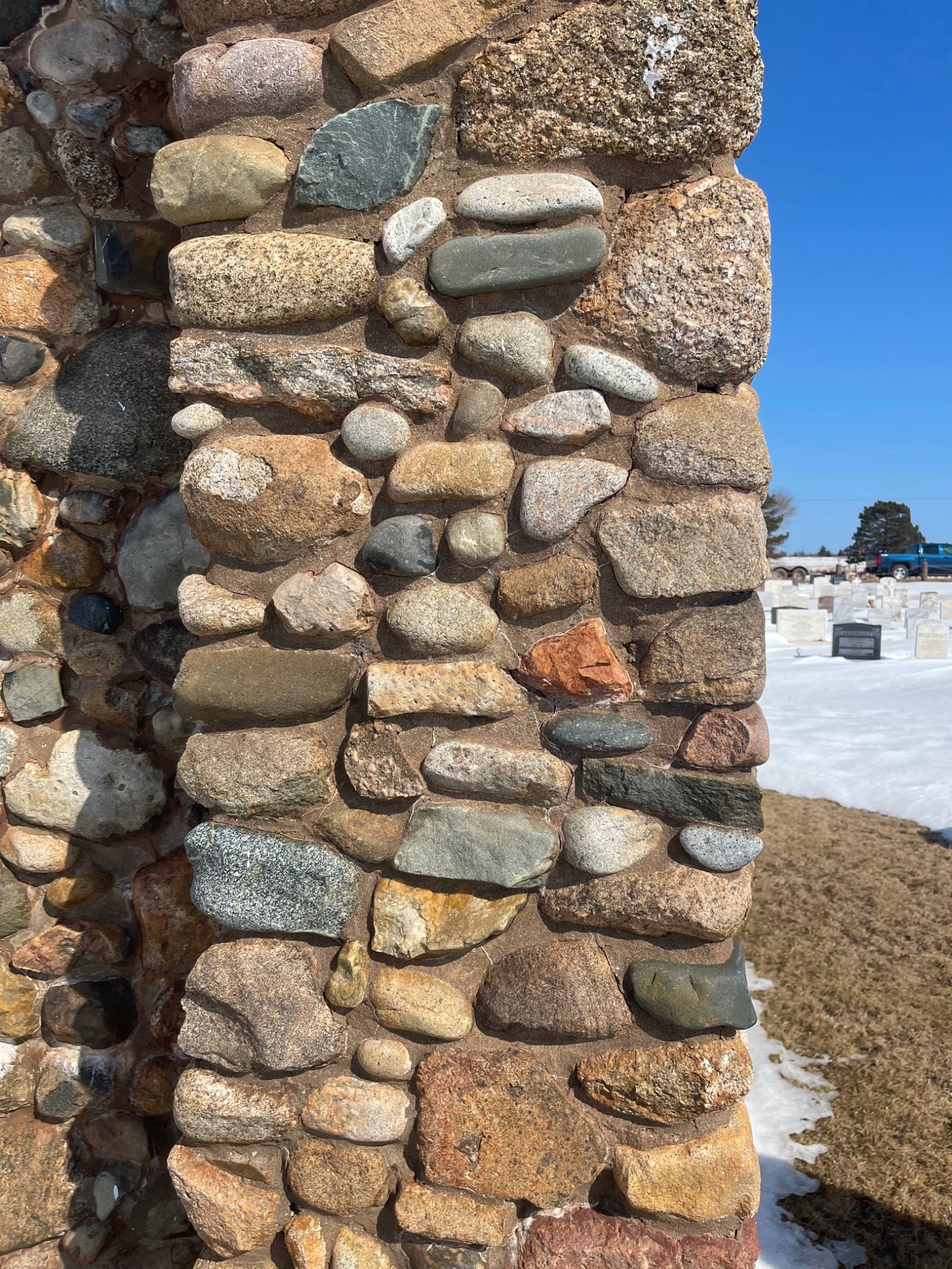Traditional fieldstone masonry showing irregular stones fitted together in a historic wall