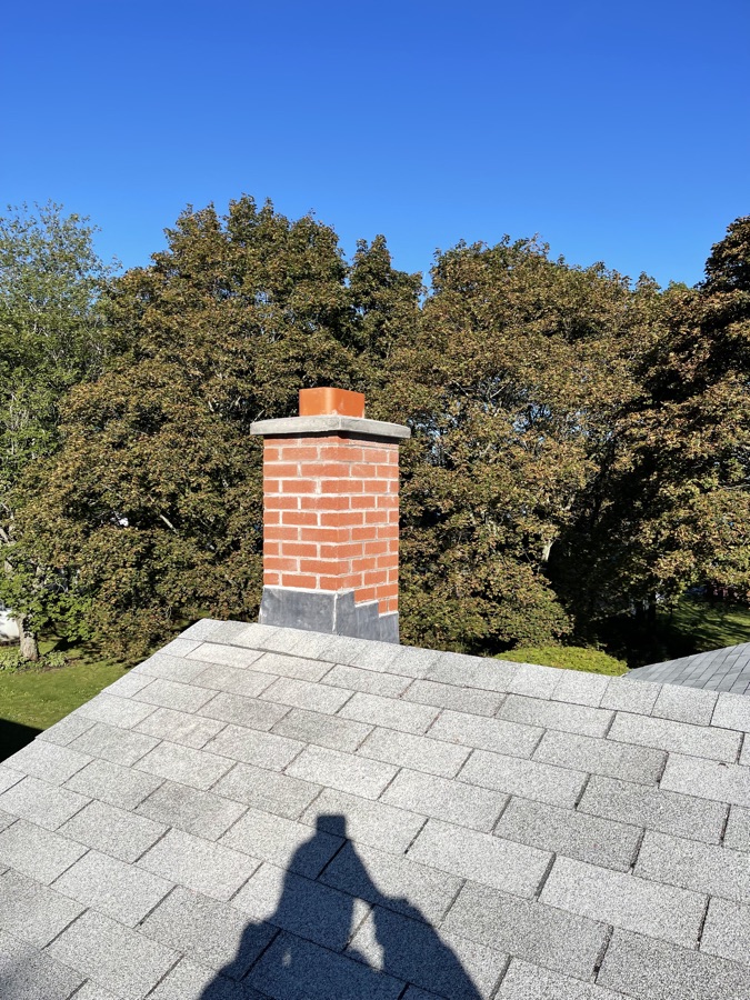 Chimney flashing and roof junction on a masonry chimney