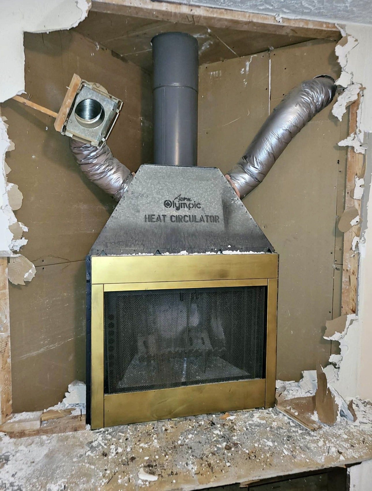 Large traditional stone and brick masonry fireplace with open firebox