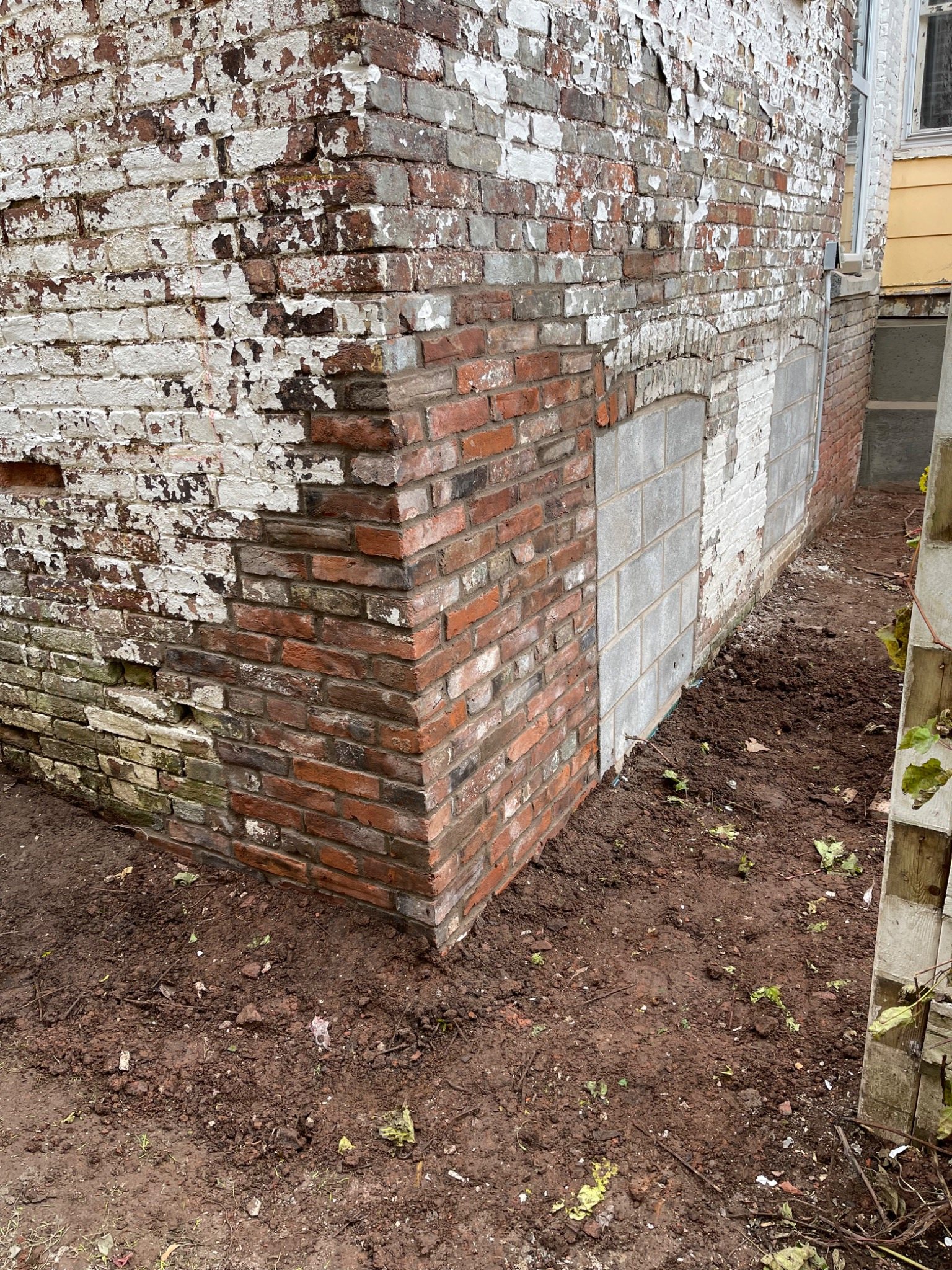 Historic brick masonry wall undergoing restoration in Prince Edward Island